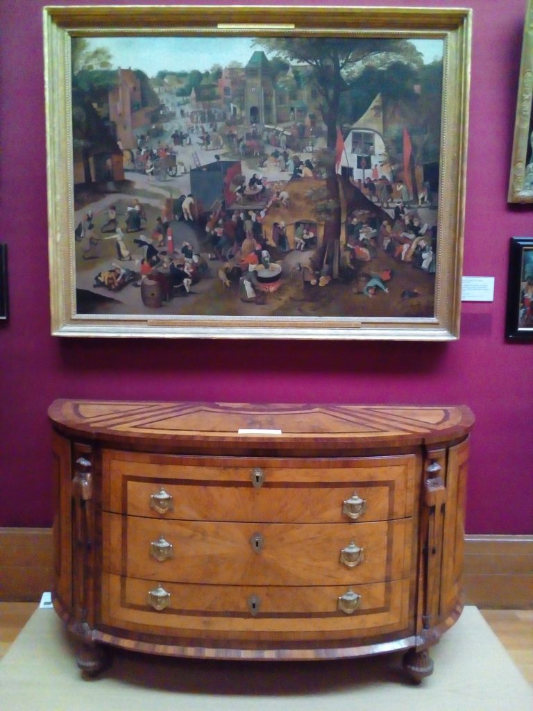 Painting on display above piece of furniture